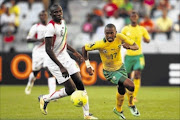 PURPLE PATCH:  Bafana Bafana striker Bernard Parker dribbles past Mali's Yaya Samake during their 2014 African Nations Championship match at Cape Town Stadium yesterdayPhoto: Shaun Roy/Gallo Images