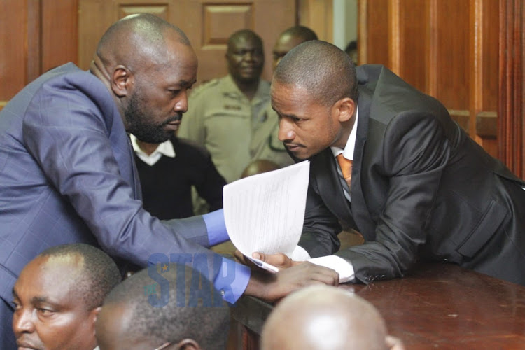 Embakasi East MP Babu Owino consults with his lawyer Cliff Ombeta at the Milimani Law Courts on Monday, January 20, 2020.