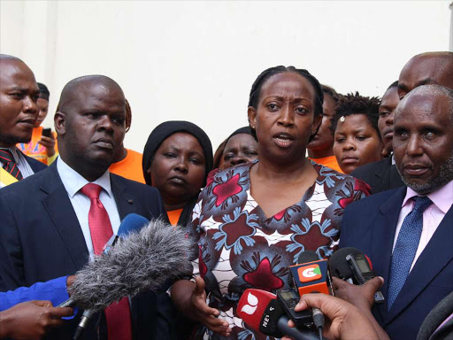 Executive director of Crawn Trust Daisy Amdany (C) and stakeholders address the press outside the Milimani law courts on Wednesday / COLLINS KWEYU