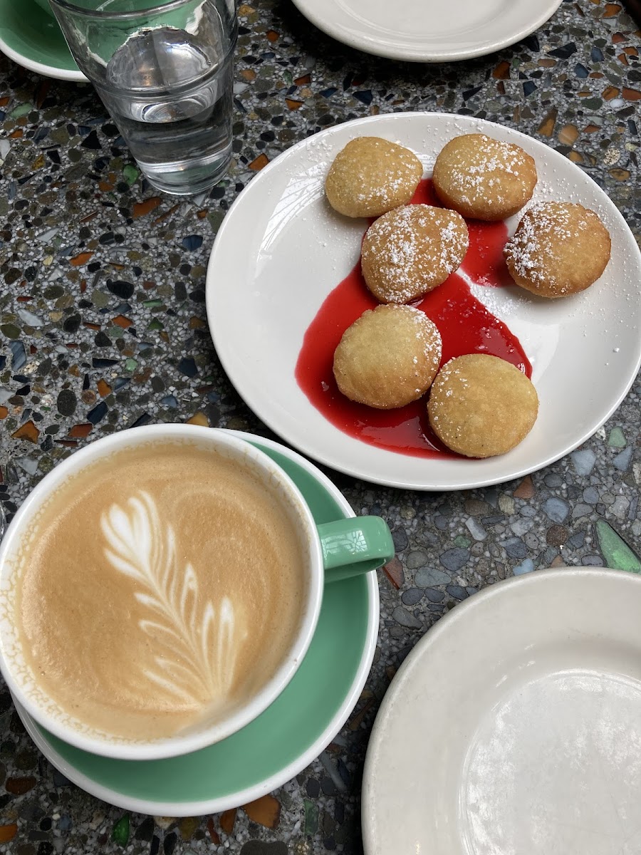 Latte, mochi beignets with raspberry coulis