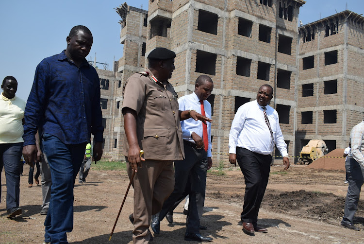 National Assembly Finance and National Planning Committee chairman Kuria Kimani with Homa Bay county commissioner Moses Lilan when they toured affordable housing project in Homa Bay town on January 19,2024