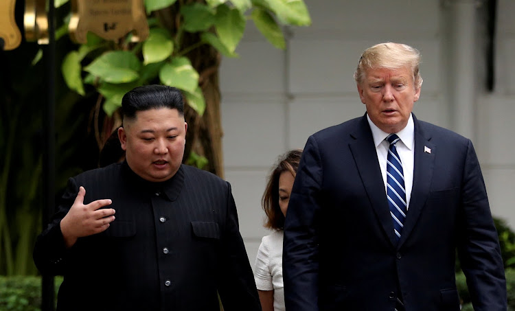 North Korea's leader Kim Jong Un and US President Donald Trump talk in the garden of the Metropole hotel during the second North Korea-U.S. summit in Hanoi, Vietnam February 28, 2019.