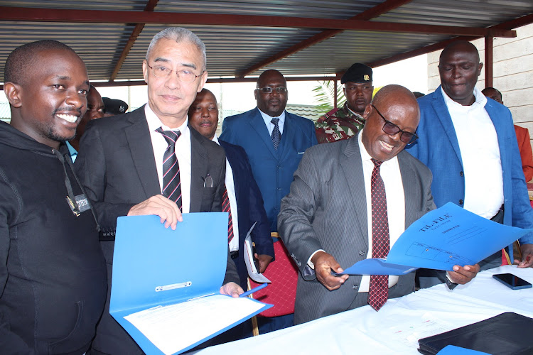 Poly Intercontinental Trading Company official Bai Junsheng and Ikumbi tea factory chairperson Onesmus Kibuna after signing the MoU on August 30, 2023.