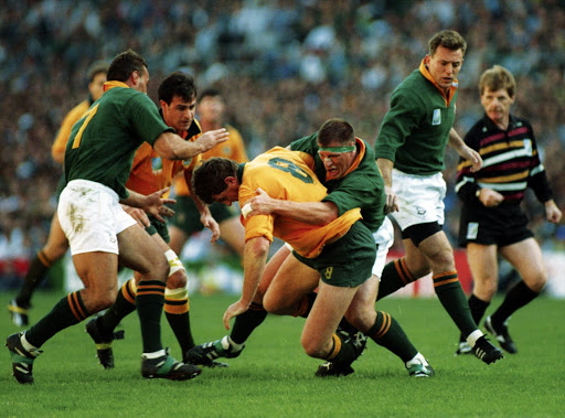 CAPE TOWN, SOUTH AFRICA: 25 May 1995, Rudolf Straeuli tackles Tim Gavin during the Rugby World Cup match between South Africa and Australia at Newlands stadium in Cape Town, South Africa. Photo by David Rogers / Gallo Images.