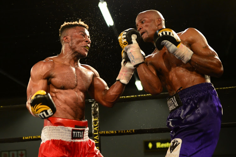 Cruiserweight Bout between Kozanga Mwanza Youssef (red trunks) and Khayeni Hlungwane (purple trunks) during the 2017 Christmas Cracker Box and Dine at Emperors Palace on December 4 2017 in Johannesburg.