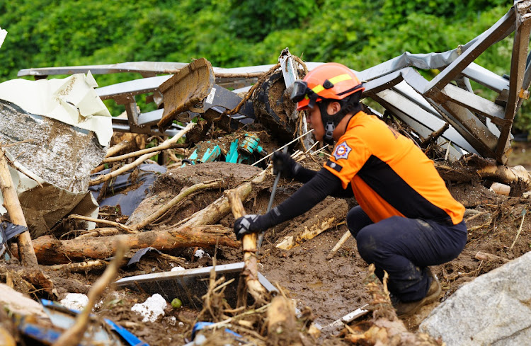 A South Korean rescue worker searching for missing persons in Yecheon, South Korea. Flooding and landslides caused by heavy rains have killed at least 37 people nationwide, authorities say, July 16 2023. Picture: SOUTH KOREA NATIONAL FIRE AGENCY/GETTY IMAGES