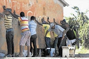 UP AGAINST THE WALL: Police conduct a stop-and-search operation this week after violent protests in Zamdela, a township of Sasolburg Picture: SIMPHIWE NKWALI