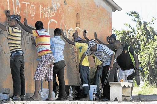 UP AGAINST THE WALL: Police conduct a stop-and-search operation this week after violent protests in Zamdela, a township of Sasolburg Picture: SIMPHIWE NKWALI