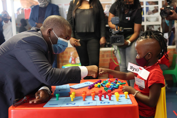 Gauteng MEC for education and youth development Panyaza Lesufi shares a light-hearted moment with grade R learner Unathi Nyakable during his first day of school at Setlabotjha Primary School in Sebokeng.