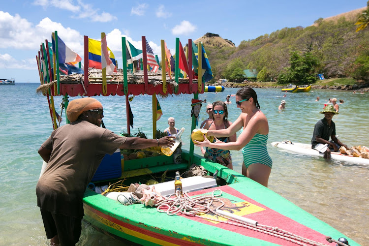 Pouring a rum drink on the beach at Pigeon Island in St. Lucia. 