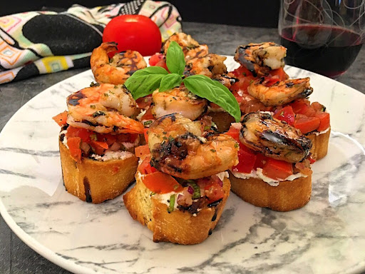 A few delicious Shrimp Bruschetta drizzled with Homemade Balsamic Glaze