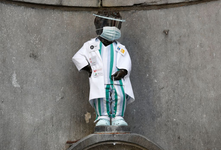 The Manneken Pis statue is dressed in an outfit paying tribute to health-care workers during the Covid-19 outbreak in Brussels, Belgium, on September 5 2020.