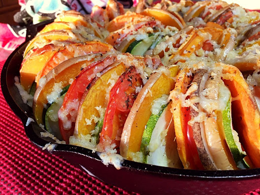 Different sliced vegetable in a cast iron pan.