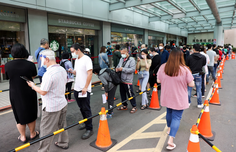 Residents queue for Covid-19 tests at the Far Eastern Memorial Hospital in New Taipei City, Taiwan, on May 23 2022. Picture: BLOOMBERG/I-HWA CHENG