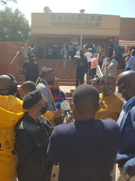 Bodyguards (in black) accompanied former Ukhozi FM DJ Ngizwe Mchunu outside the Randburg magistrate's court on Thursday.