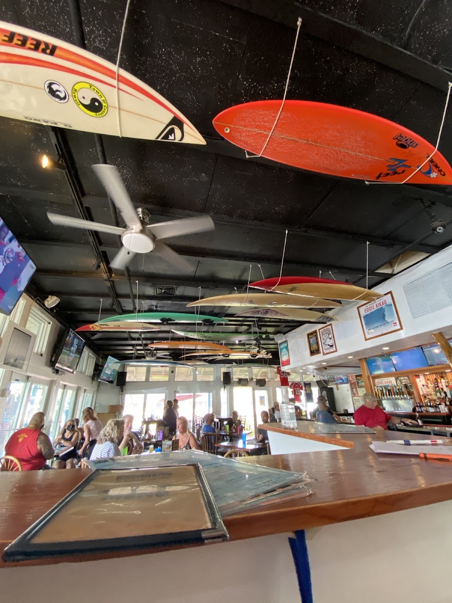 Interior of Breakers with surfboards suspended from the ceiling