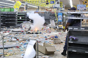 Police clear a shopping centre with stun grenades in Alexandra, Johannesburg, during the looting. File photo.
