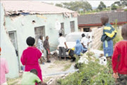 BUS DAMAGE: The family counts their blessings after a bus plunged into their home. 14/03/09. Pic. Mhlaba Memela. © Sowetan.