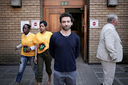 Dr Marlon Germon poses for a portrait outside the North Gauteng High court in Pretoria. Germon is a qualified medical doctor who has travelled abroad to study the benefits of medical marijuana.