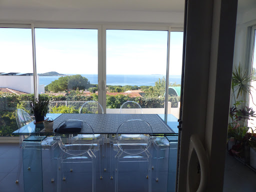 Dining table glass sea view in this luxury villa for sale in Albitreccia ($1,413,793 - 137 m²)