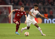 Karim Adeyemi of FC Red Bull Salzburg runs with the ball under pressure from Benjamin Pavard of FC Bayern Muenchen during the UEFA Champions League Round Of Sixteen Leg Two match between Bayern München and FC Salzburg at Football Arena Munich on March 08, 2022 in Munich, Germany. 