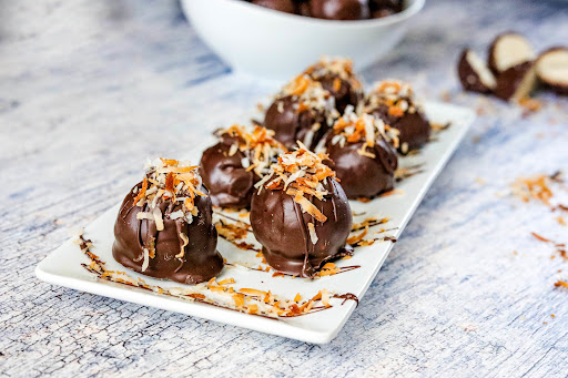 A platter of Coconut Balls with toasted coconut on top.