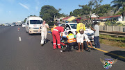 Rescure Care paramedics attend to a truck driver and his conductor who were both critically wounded  during a shooting on the busy Higginson highway on Tuesday.