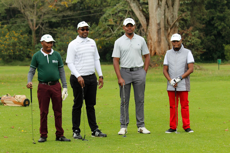 Okolea International director George Njuguna (2nd L) and other golfers