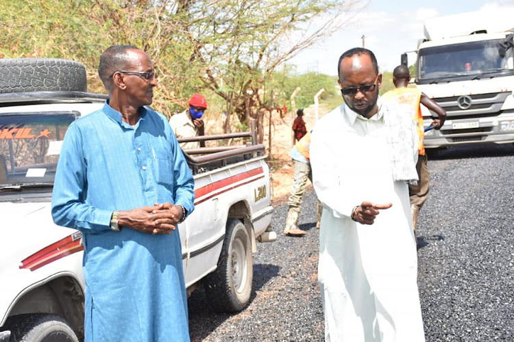 Lands, Urban Planning, Housing and Public Works executive Abdi Omar with Garissa Municipality acting CEO Abdinoor ole Hussein during the commissioning of the construction works of two key roads