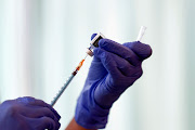 A medical worker fills a syringe with a dose of the Pfizer-BioNTech coronavirus disease (Covid-19) vaccine as Japan launches its inoculation campaign, at Tokyo Medical Center in Tokyo, Japan February 17, 2021. 