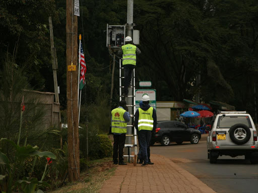 Technicians repairs a CCTV camera along Harry Thuku Road, July 23, 2016. /ENOS TECHE