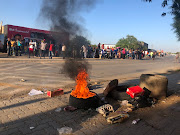 Several roads in the area had been blocked off with rocks and burning tyres. 