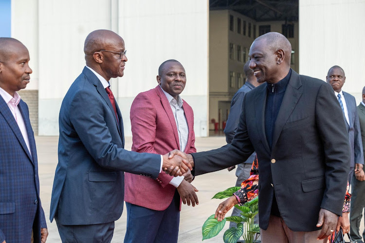 President William Ruto shakes hand with Chief of Defence Forces Francis Ogola as other leaders look on when he departed for Italy at JKIA on January 28, 2024.