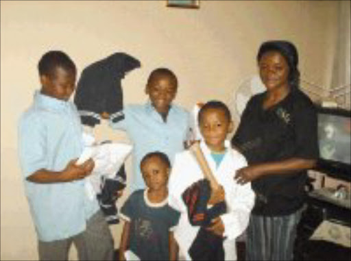 TOUGH LIFE: Rita Kabula, a refugee from the Democratic Republic of Congo who now lives in Joburg, is seen with her four sons who received school uniforms, jerseys and staionery from Mama Angel. Pic. Lucky Nxumalo. 06/02/08. © Sowetan.