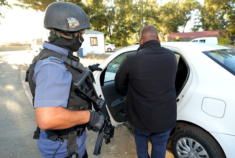 Five Western Cape police officers and two clerks were arrested for allegedly issuing fraudulent vehicle registration papers.