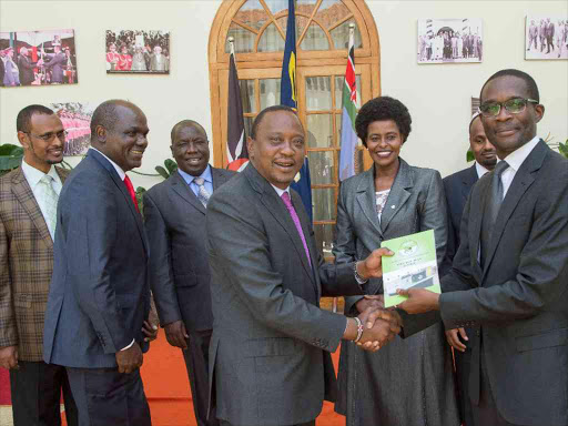 President Uhuru Kenyatta receives the IEBC Strategic Plan for 2015-2020 from CEO Ezra Chiloba at State House in Nairobi. /FILE