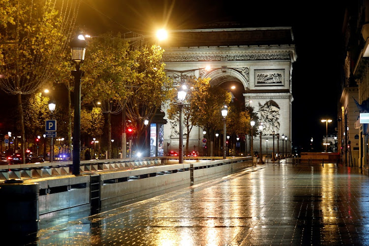 A deserted Champs-Elysees avenue is seen near the Arc de Triomphe during the nightly curfew imposed to curb the spread of the coronavirus disease (Covid-19) in Paris, France, October 27, 2020.