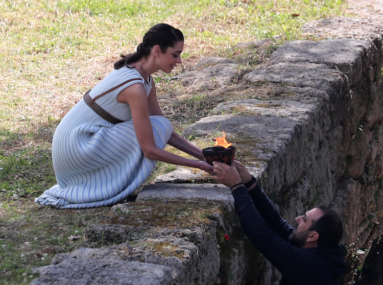 Greek actress Xanthi Georgiou, playing the role of High Priestess carries the flame during the dress rehearsal for the Olympic flame lighting ceremony for the Tokyo 2020 Summer Olympics