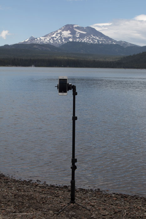 Using a tripod for iphoneography, pointed towards a lake and mountain