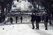 Investigators work near the site of an explosion on 2nd Avenue that occurred the day before in Nashville, Tennessee, US December 26, 2020. 