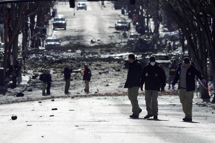 Investigators work near the site of an explosion on 2nd Avenue that occurred the day before in Nashville, Tennessee, US December 26, 2020.