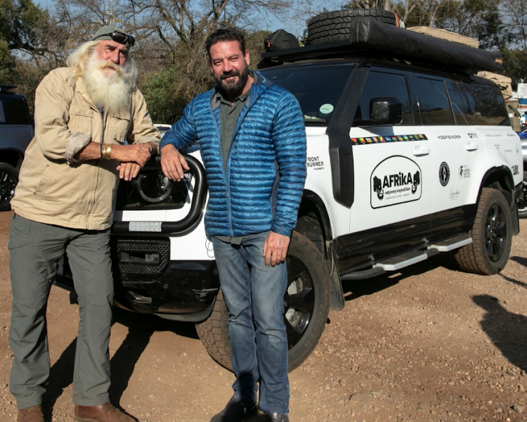 Kingsley and Ross Holgate pose next to the heavily loaded Defender 130 model they will use to travel to 12 African countries.