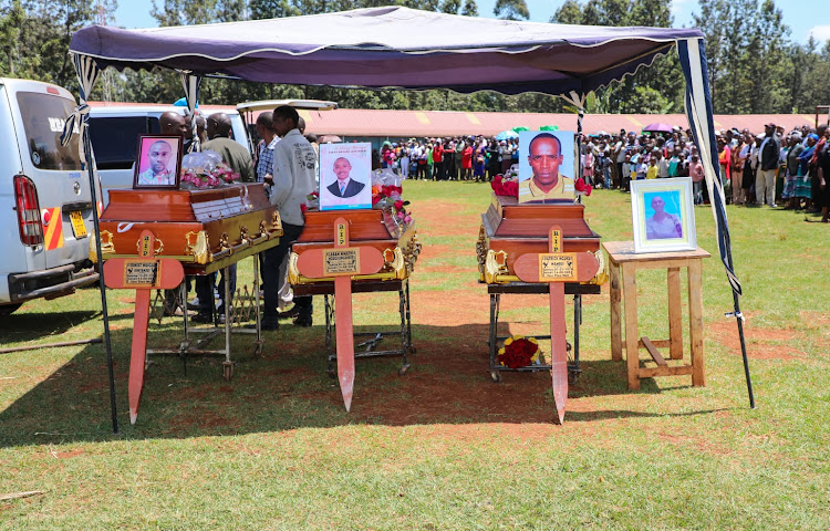 Casckets bearing the remains of Earnest Muigai, Patrick Nguku and Laban Mwathi during the burial mass at Ndekei primary school in Gatundu North on Wednesday.