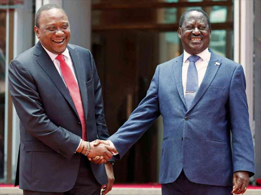 President Uhuru Kenyatta greets opposition leader Raila Odinga after addressing a news conference at the Harambee House office in Nairobi on March 9, 2018. / REUTERS