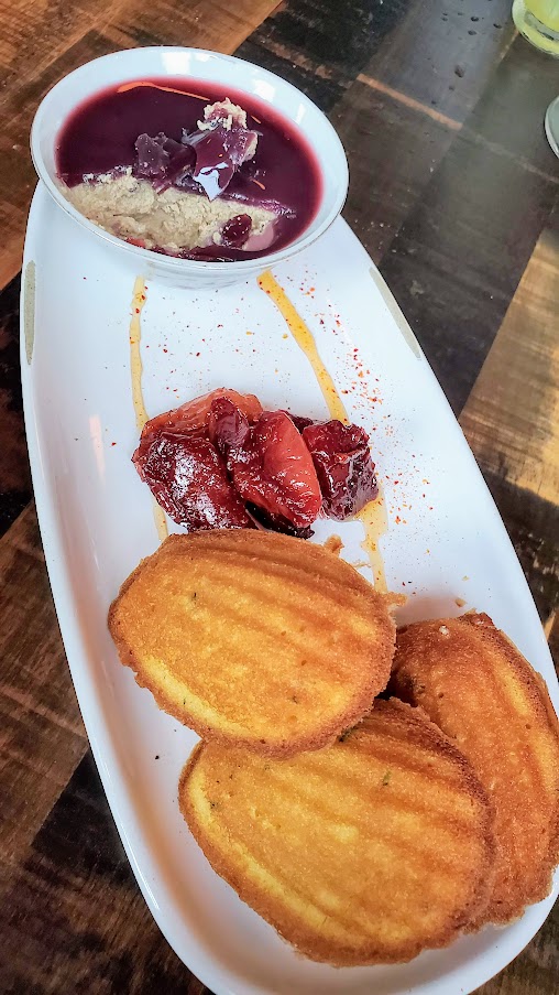 Duck Fat Madeleines, Port Poached Plums, Piment d’ Espelette Honey available at dinner and happy hour at Normandie PDX