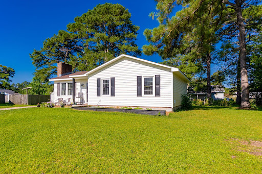 White house with green lawn in this luxury house for sale in Havelock ($220,000)
