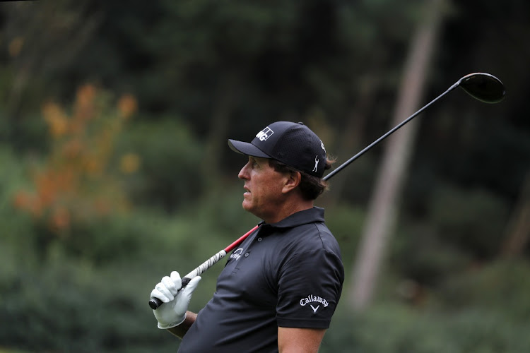 Phil Mickelson of the US watches his tee shot on the 14th hole during a practice round at Augusta National Golf Club on November 10, 2020