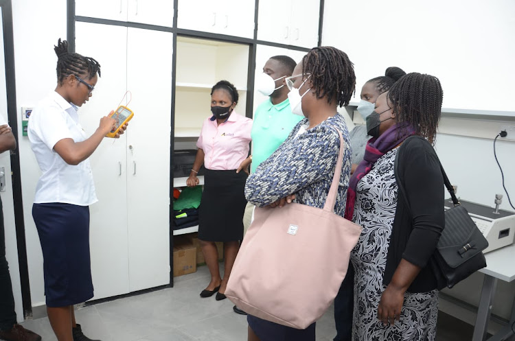 Amotech Africa lab manager Beth Wanjiku explaining on the pressure calibrator to Bank of Uganda team at Amotech offices in Nairobi./DOUGLAS OKIDDY