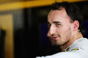 Robert Kubica of Poland and Renault F1 Team watches on during the Formula 1 Pirelli Tyre Testing at the Yas Marina Circuit on November 19, 2010 in Abu Dhabi, United Arab Emirates