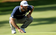 Dustin Johnson of the United States lines up a putt on the 14th green during the second round of the Masters at Augusta National Golf Club on November 13, 2020.